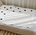 Waterproof diaper changing mat made of cotton and polyester, 65 x 85 cm, with black polka dot pattern, made in Korea.