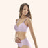 Woman wearing a comfortable bamboo bra and matching underwear set in light purple, showcasing eco-friendly material and soft texture.