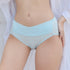 Woman wearing light blue air silk panties with a V-curve design and low rise, eco-friendly, soft and hygienic material for pregnancy comfort.